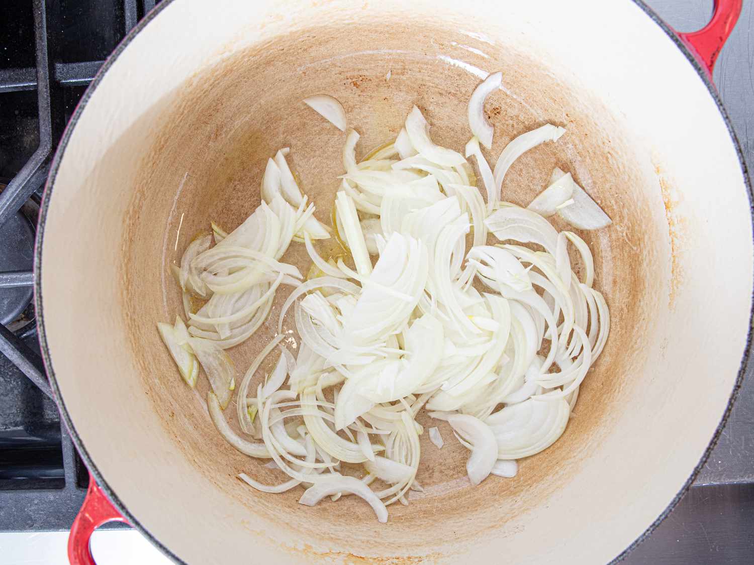 Overhead view of onions in a dutch oven