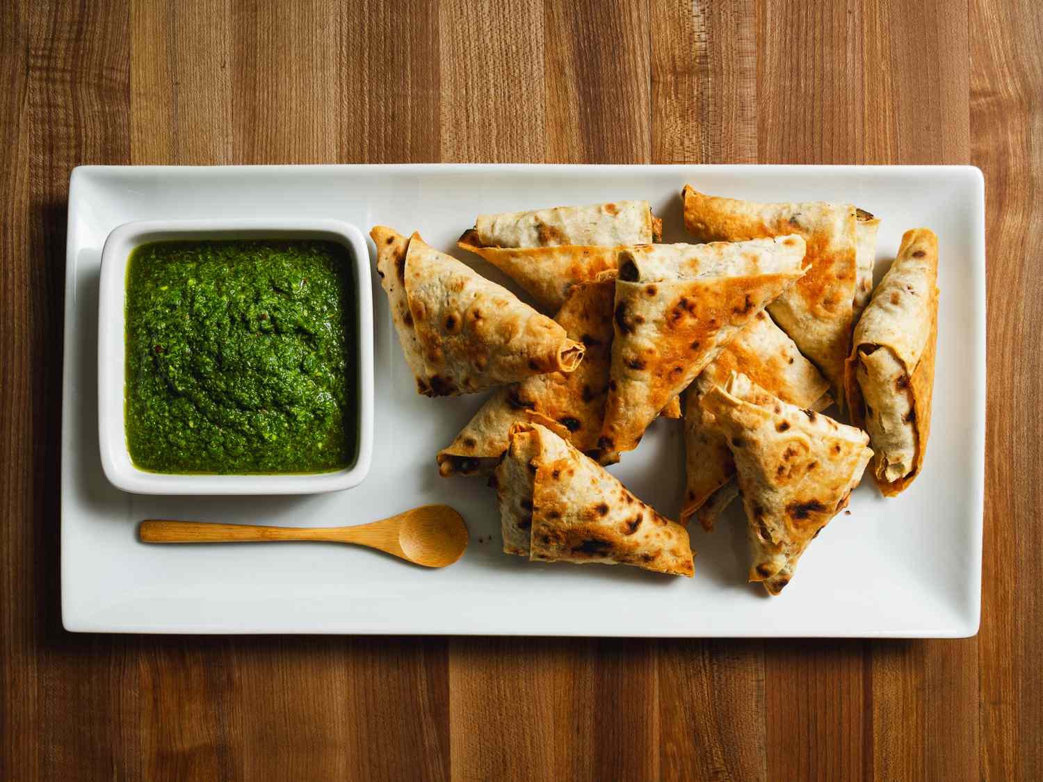 Lavash triangles served with dipping sauce.