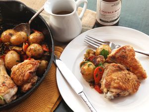 A skillet and plateful of pan-roasted chicken and vegetables with Dijon jus.