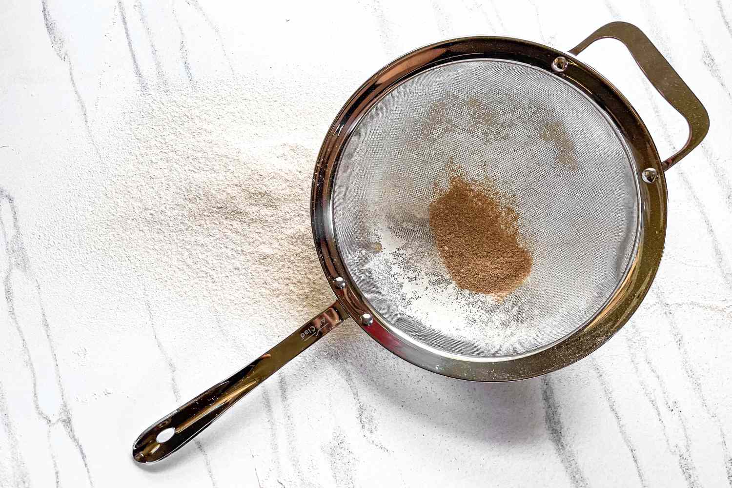 All-Clad Stainless-Steel Strainer, Set of 3 on a marbled surface