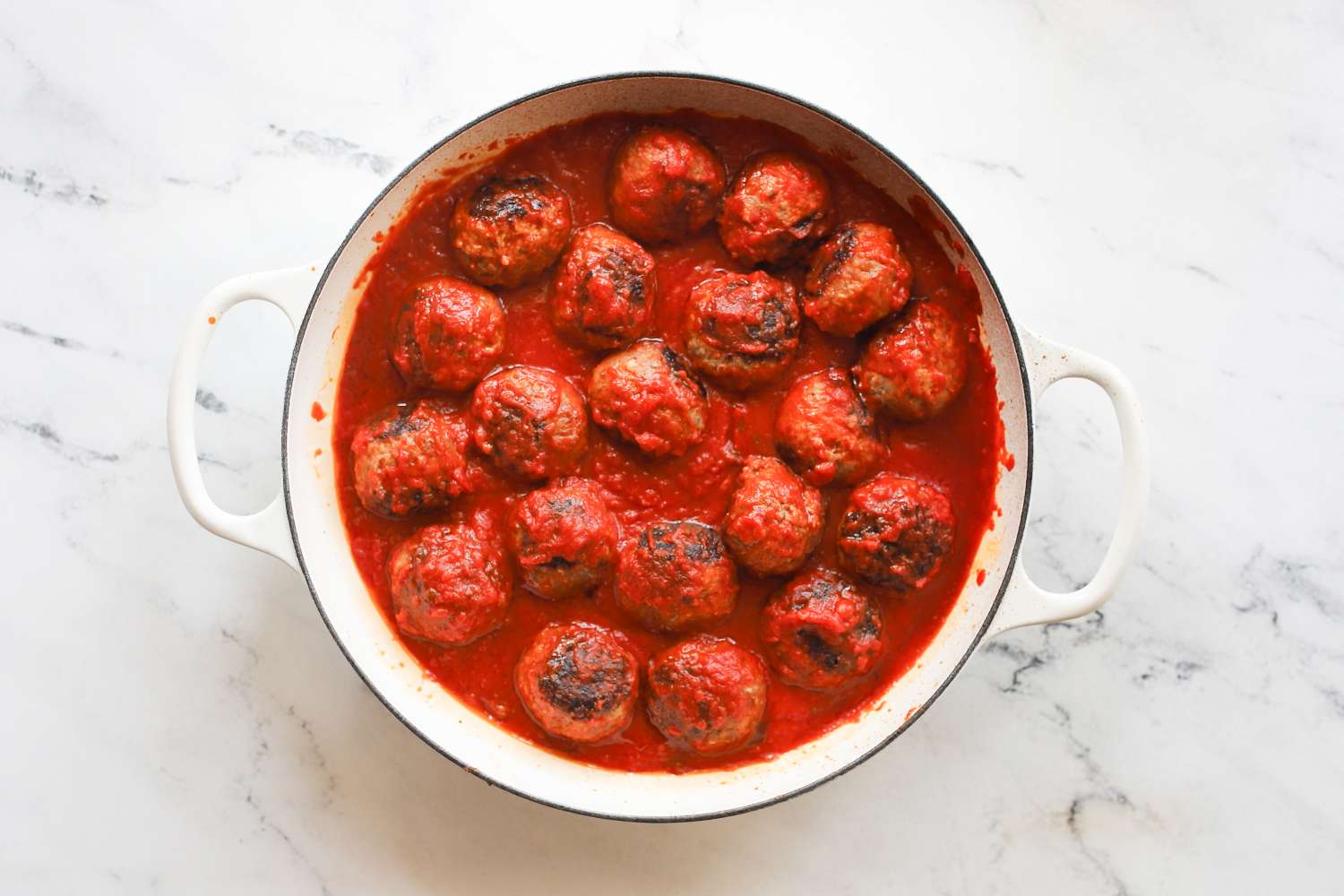 A pot filled with meatballs in tomato sauce