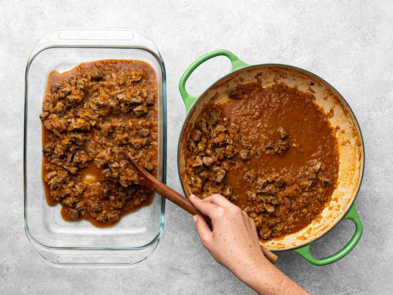Hand scooping cooked beef mixture from a green pot into a glass dish, preparation step for Chilean beef empanadas.