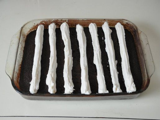 Vanilla buttercream piped into "bumps" on the chocolate cake.