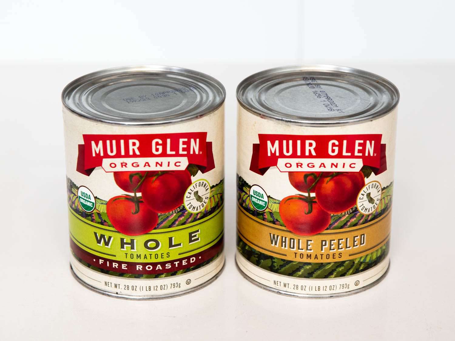 Side by side comparison of canned fire-roasted whole tomatoes and plain canned whole tomatoes