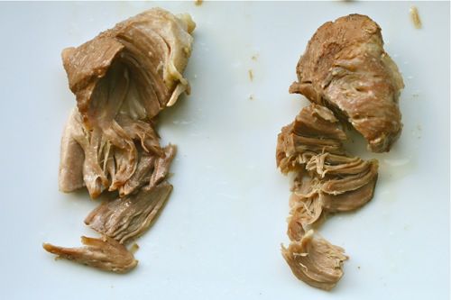 Side-by-side image showing pork shoulder cooked in lard (left) and stock (right).