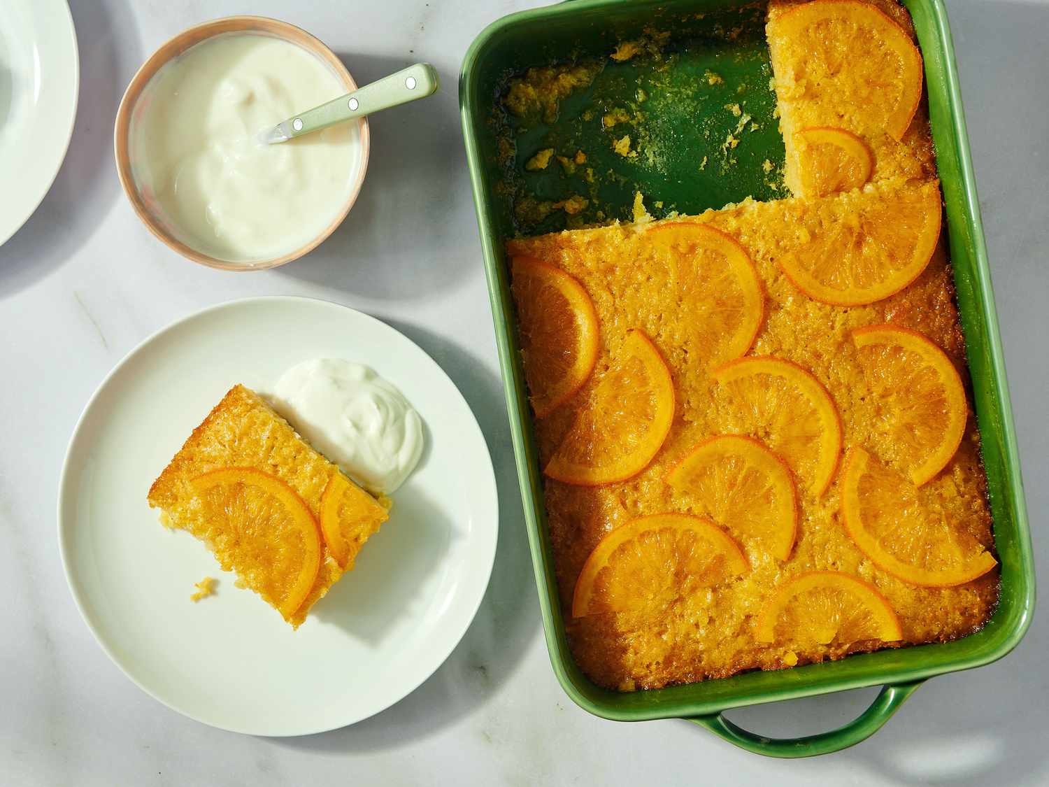 A tray and plate of portokalopita, a traditional Greek orange cake