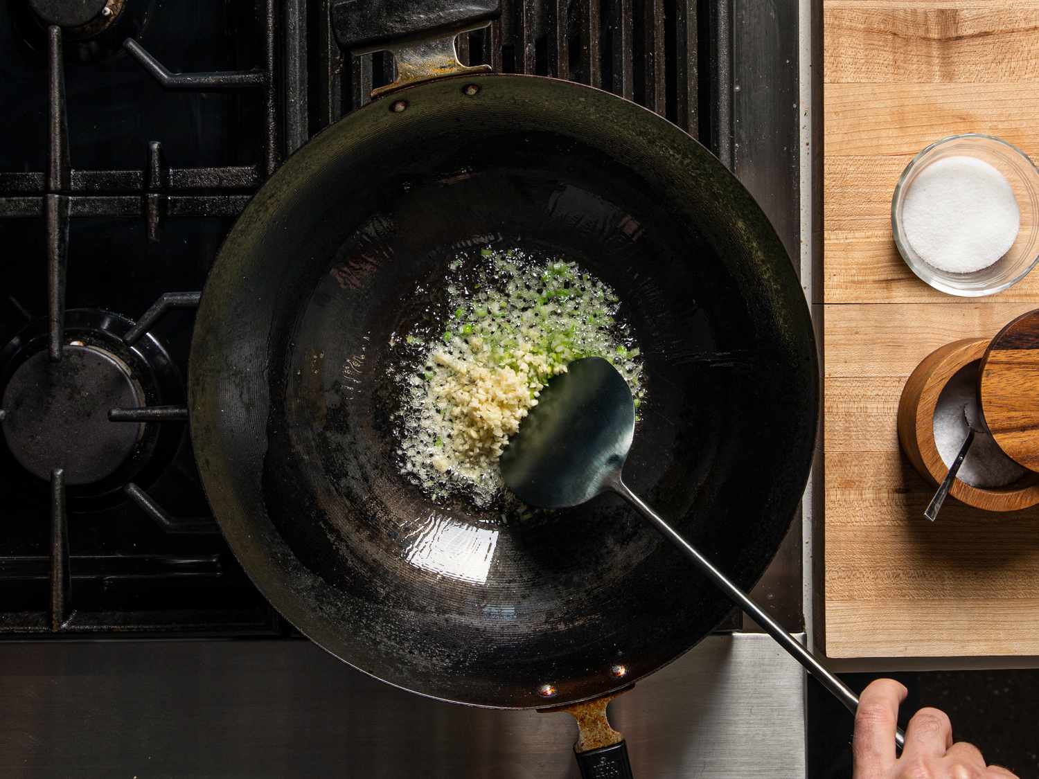 Ginger and scallions frying in a wok.