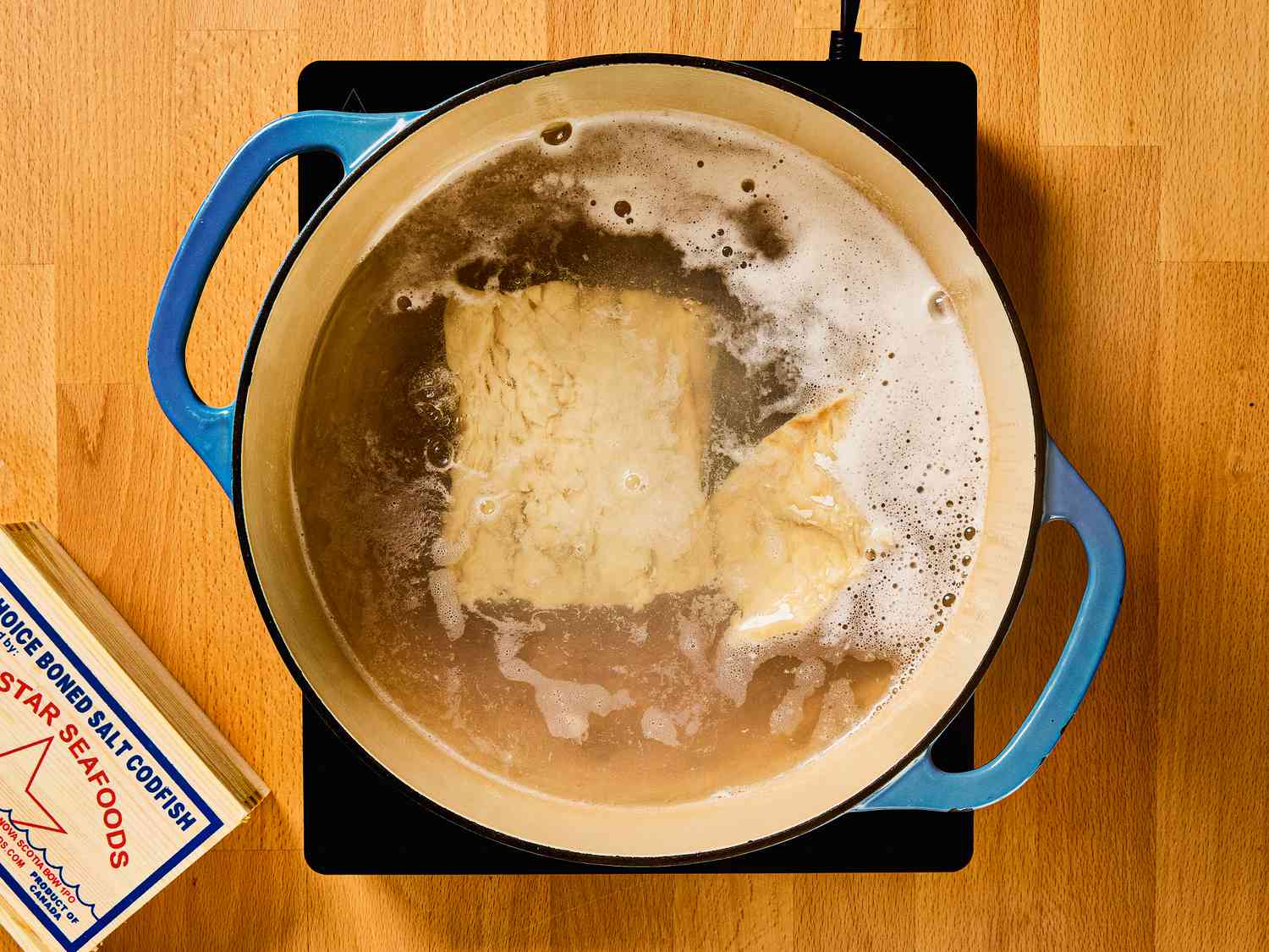 Cod in a dutch oven simmering in a dutch oven 