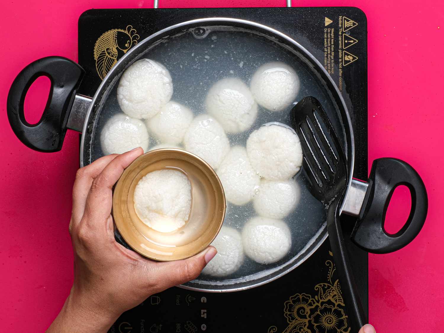 Overhead view of scooping Rasgulla