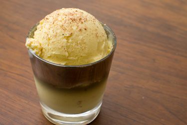 a scoop of eggnog ice cream garnished with nutmeg