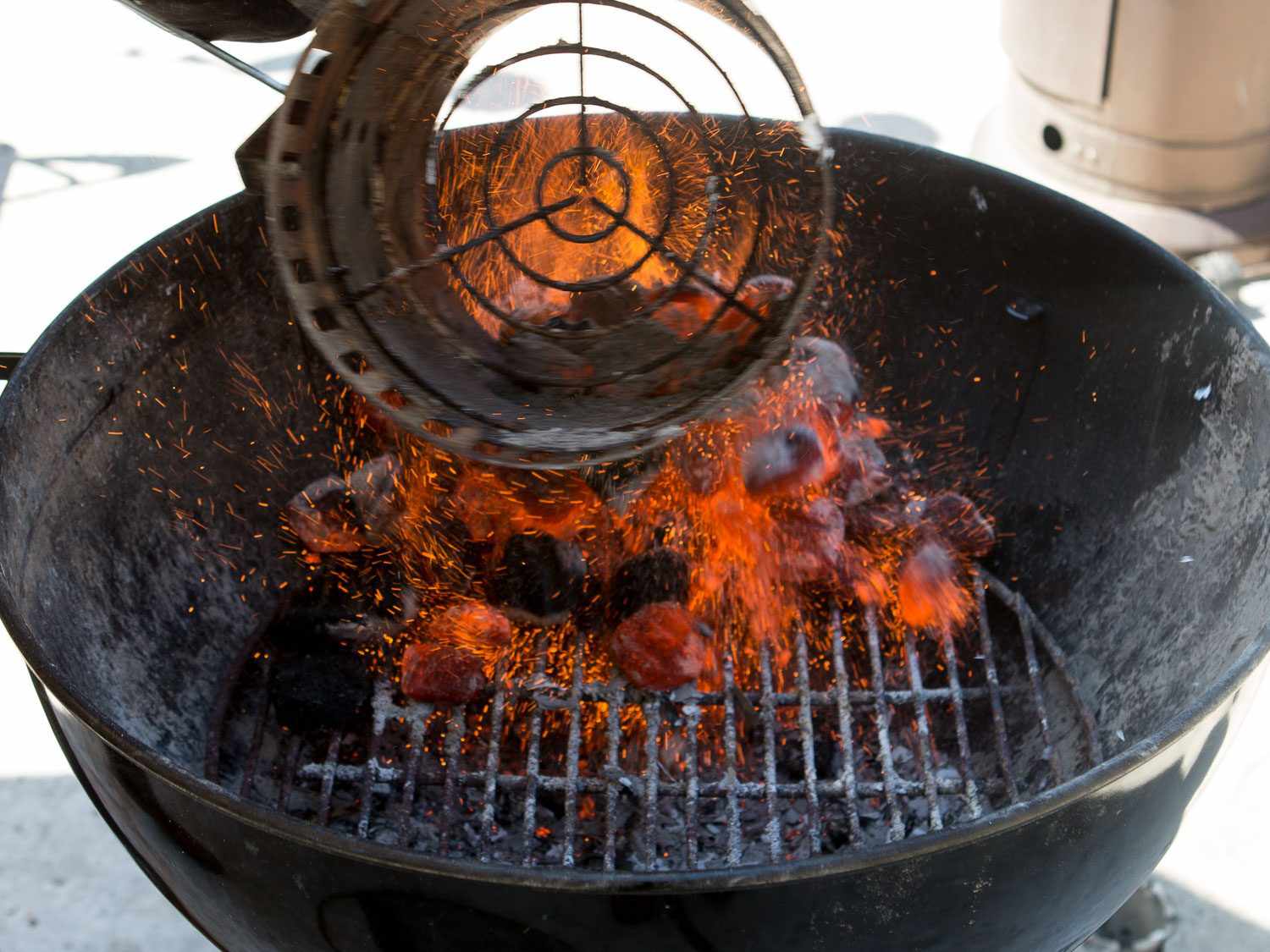 Adding lit charcoal to a grill
