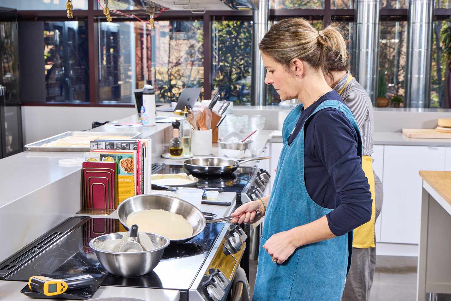A person cooks using the All-Clad D3 Stainless-Steel 12-Inch Fry Pan