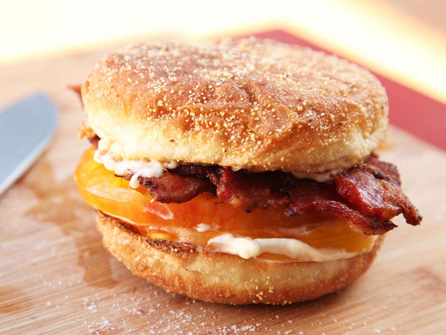 Finished bacon, mayo, and tomato sandwich on a toasted English muffin