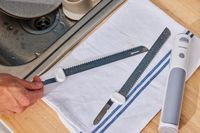 a person washing the blades from the nutrichef slicer