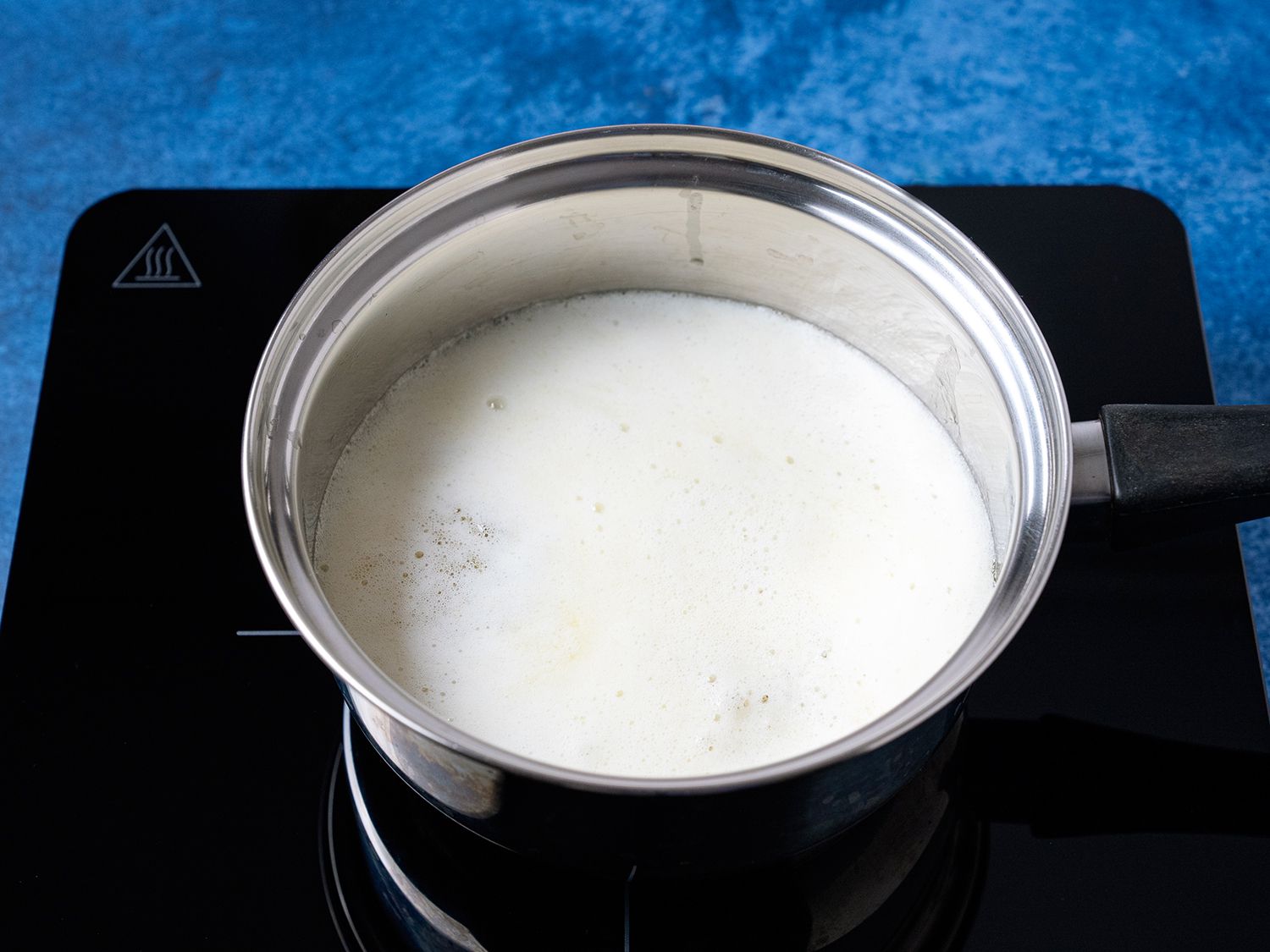 A pot of butter with a top layer of white milk proteins