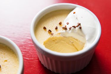 A ramekin of roasted buckwheat custard dessert with a spoonful removed.