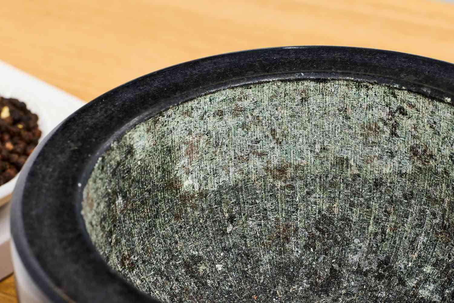 The ridged interior of a granite mortar and pestle.