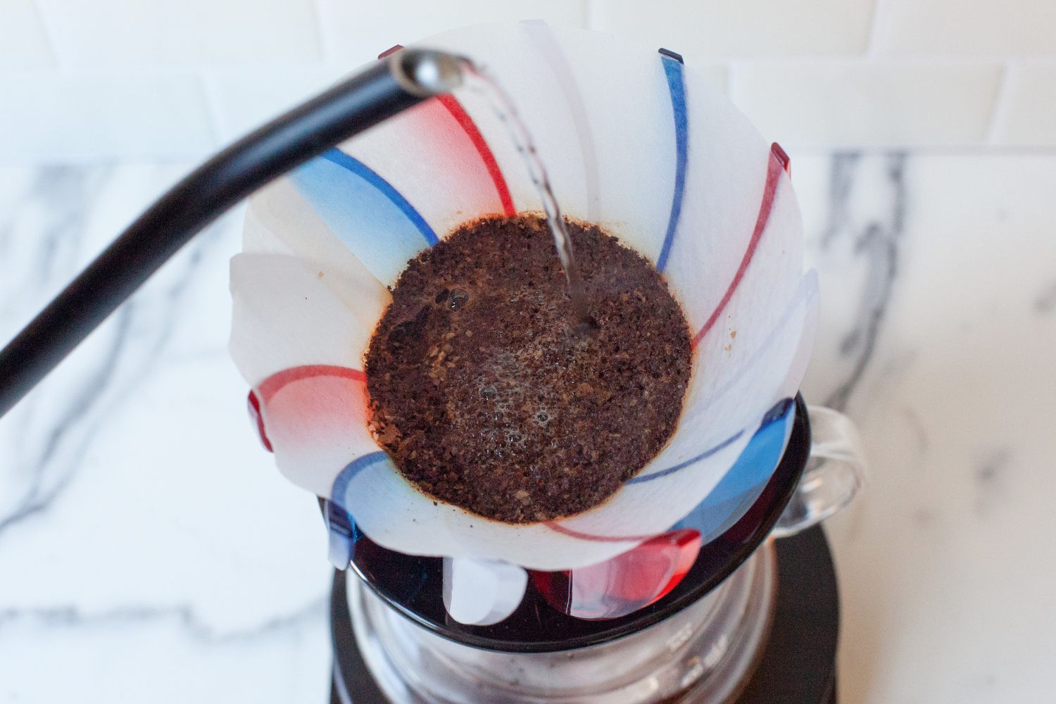 Water being added onto coffee grounds in the Hario Suiren.