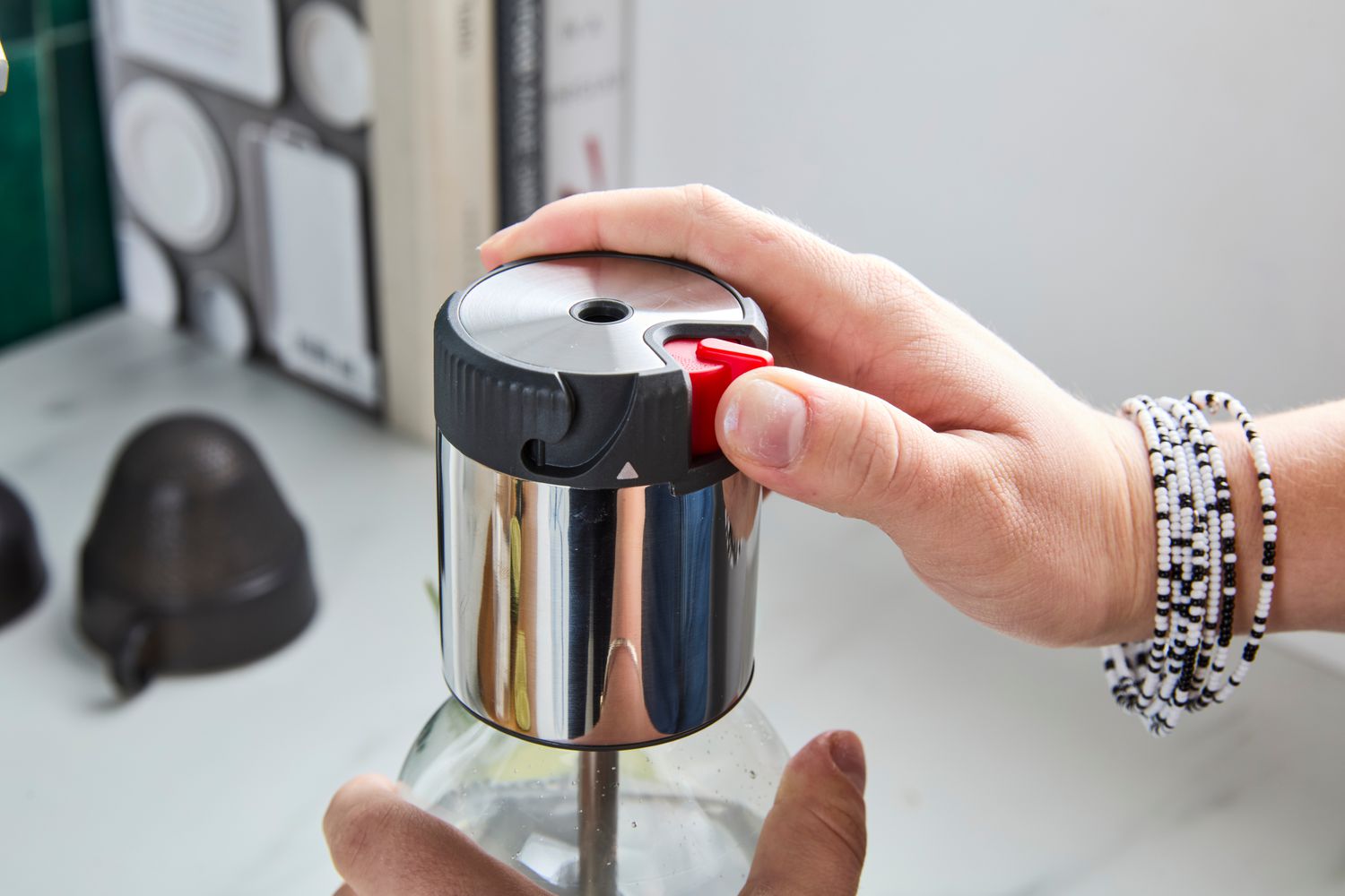 A person releasing CO2 from the Breville soda maker.