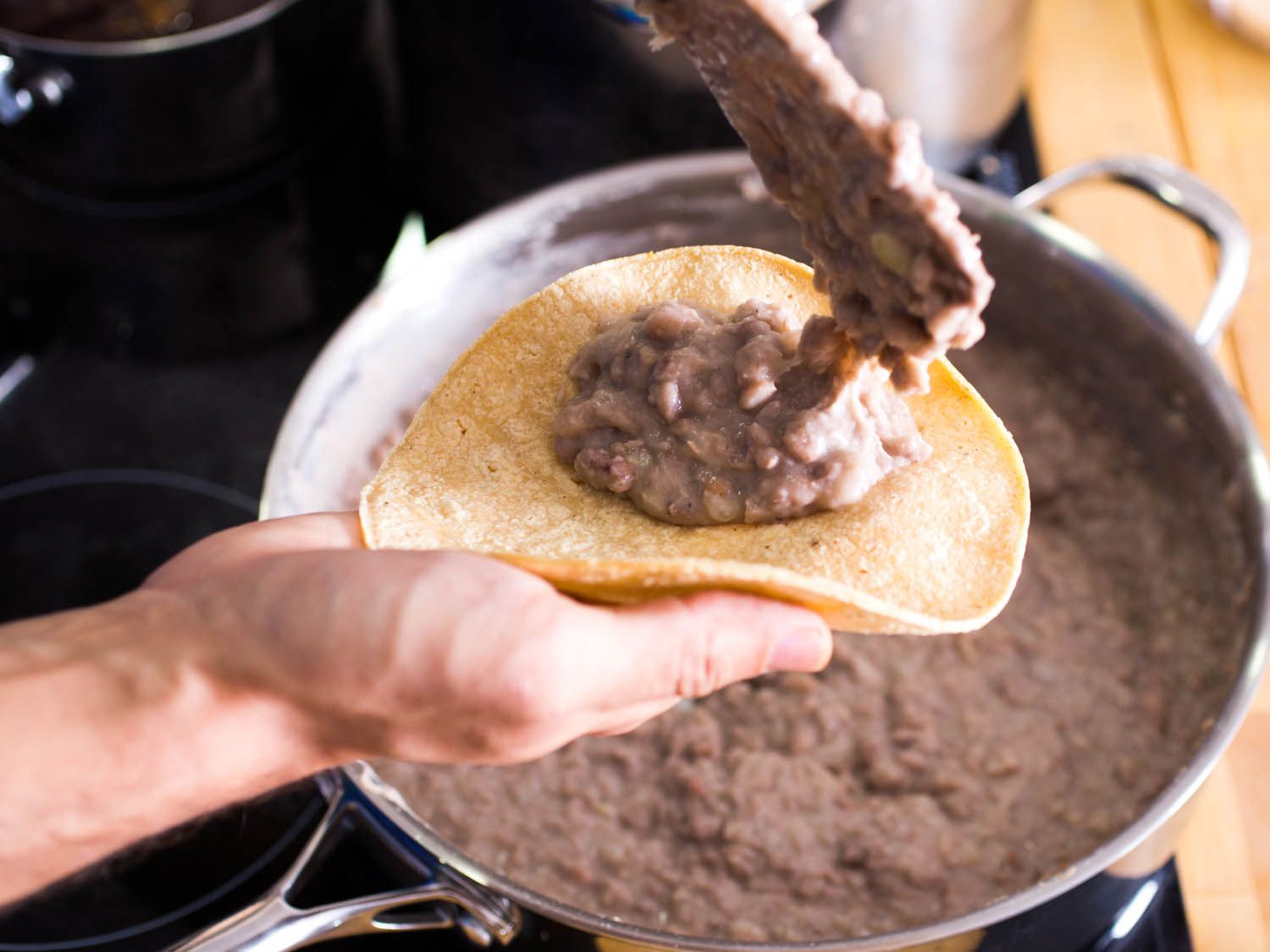 Topped corn tortilla with refried beans
