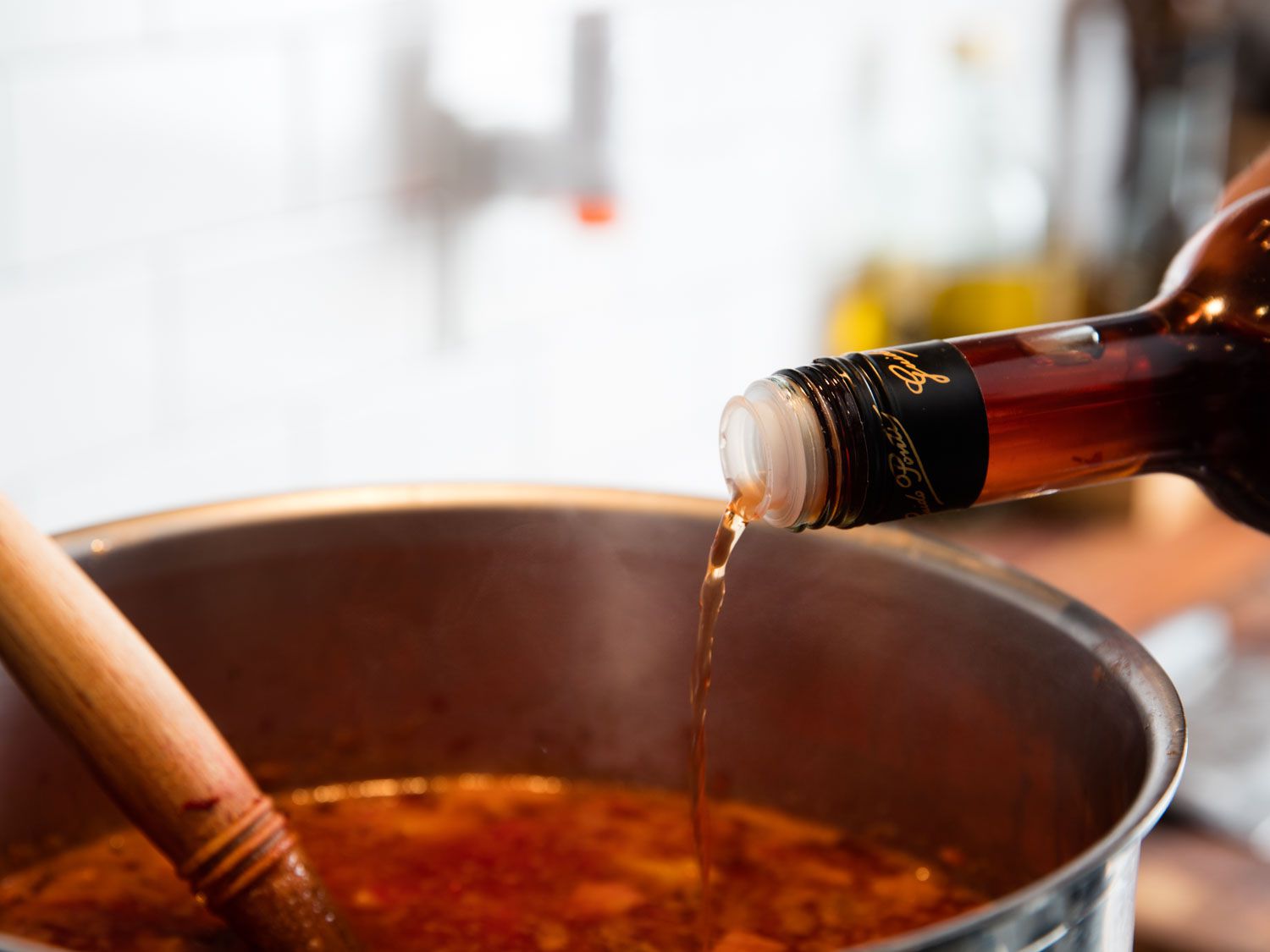 Adding vinegar to finish off borscht.