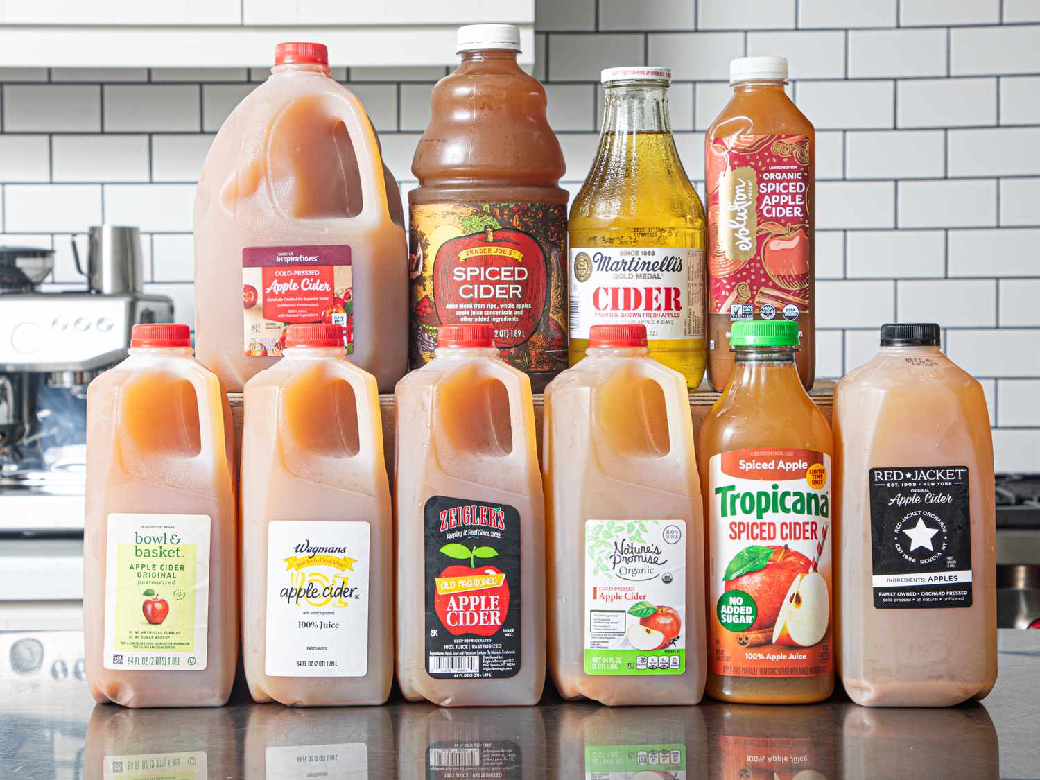Assortment of apple cider bottles arranged on a counter