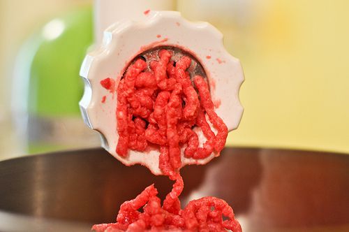 Beef coming out of a meat grinder.