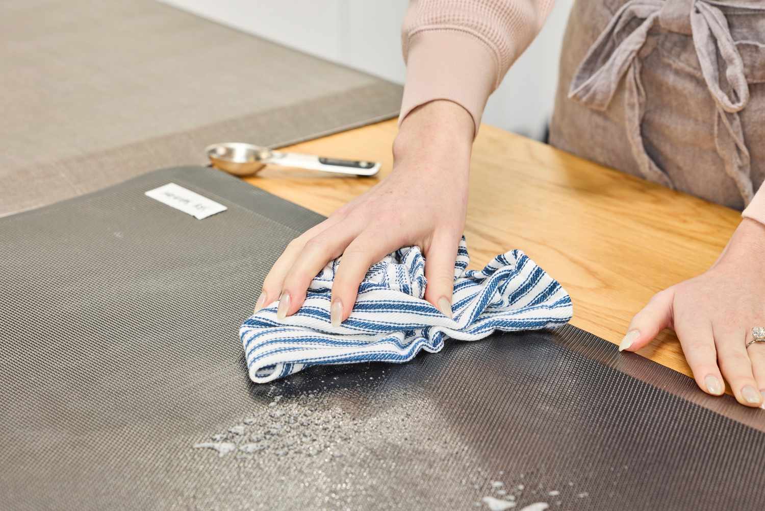 A person wipes down the Sky Solutions Sky Mat 0.75-Inch Comfort Anti-Fatigue Mat