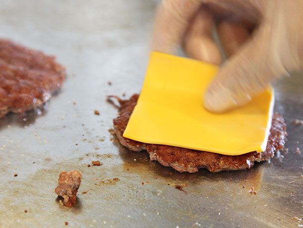 Topping smash burger with a slice of cheese