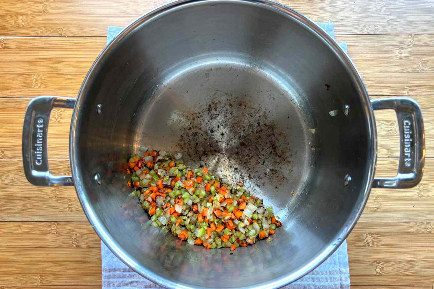 Mirepoix cooking in a stainless steel stockpot.