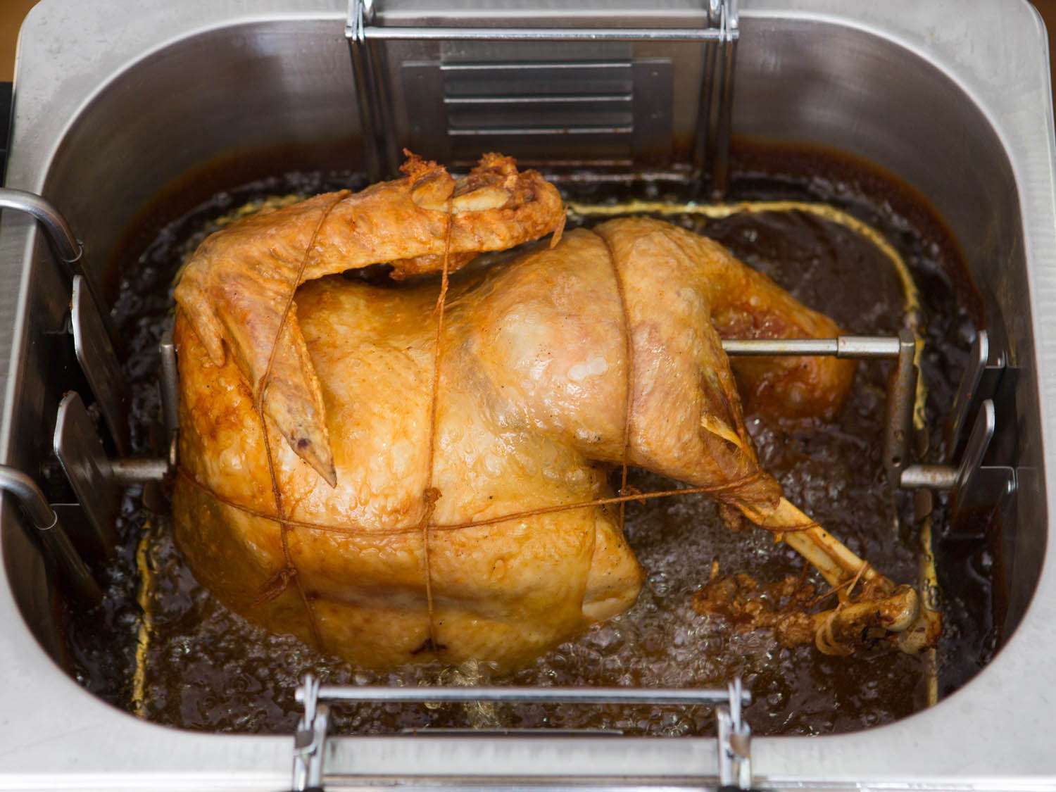 A turkey deep frying in an indoor frying device 