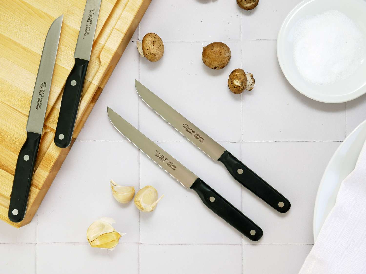 williams sonoma steak knives on a white tile surface