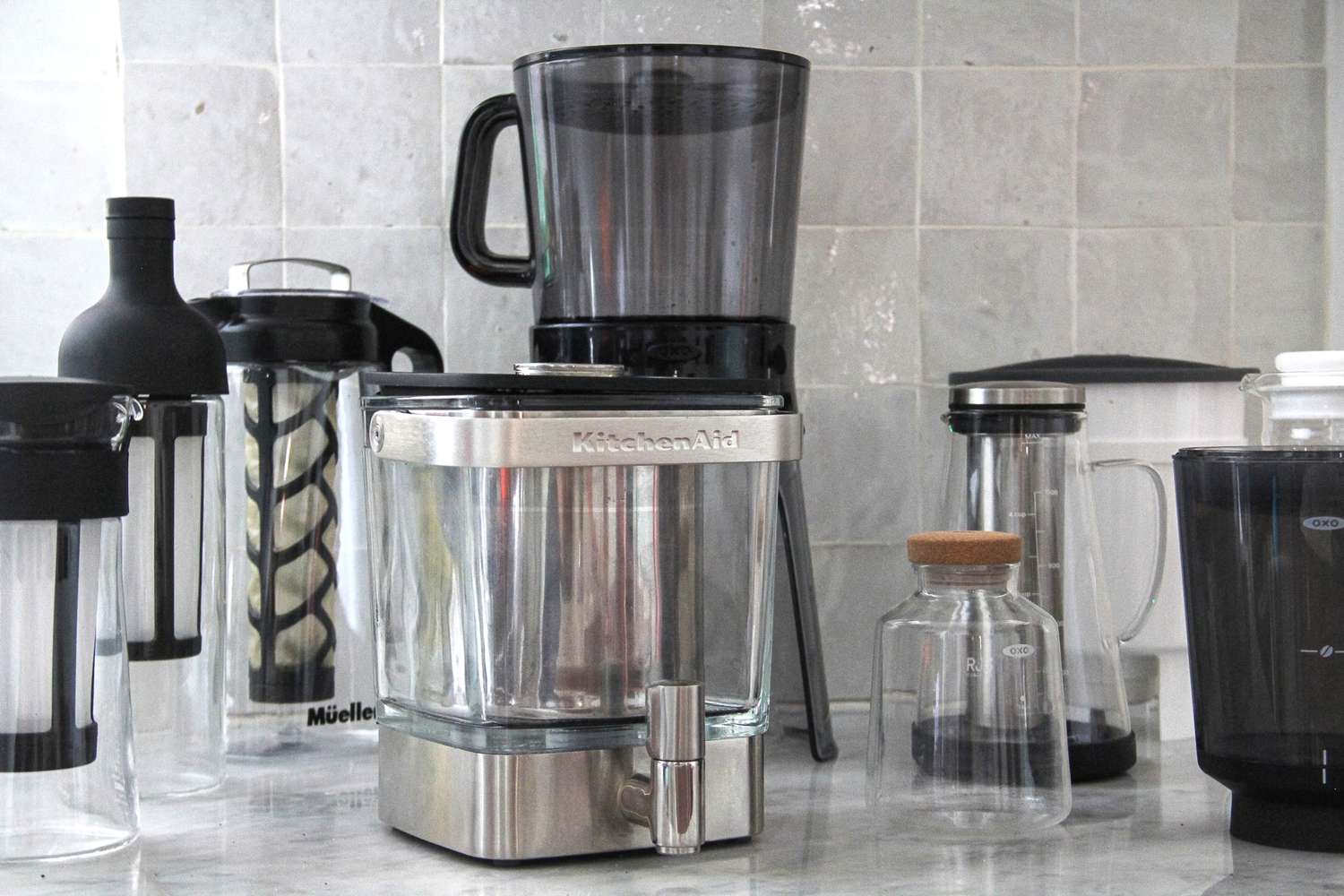 Numerous cold brew maker son a kitchen countertop.