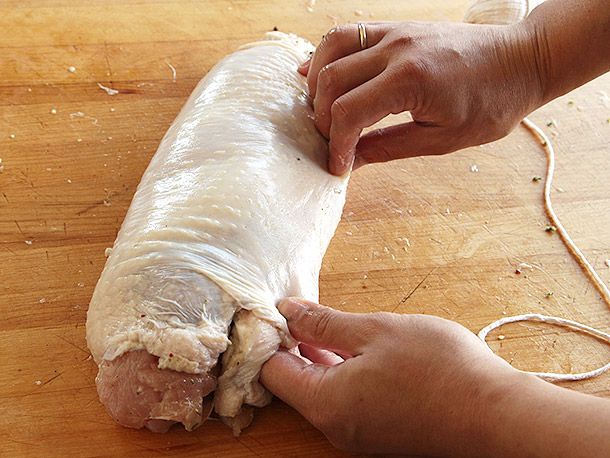 Sealing the turkey skin tightly around rolled turkey breast meat to make turkey porchetta (turchetta).