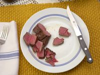 the zwilling steak knife on a plate with sliced steak