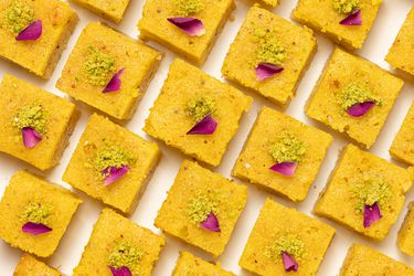 Baklava cake squares lined up on a white surface 