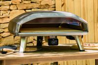 The Ooni Koda 2 Max Gas Powered Pizza Oven on an outdoor table