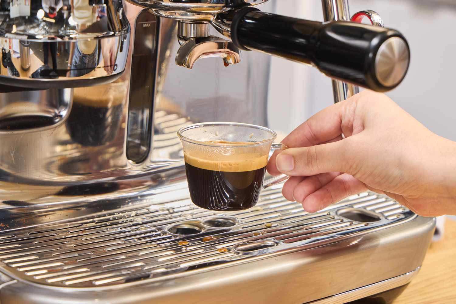 An espresso shot is made using the Breville The Oracle Jet Espresso Machine