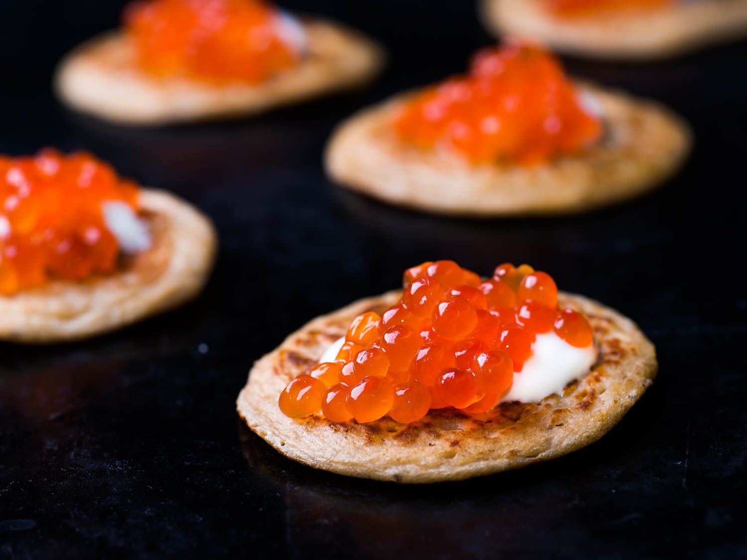 Blini topped with sour cream and caviar. 
