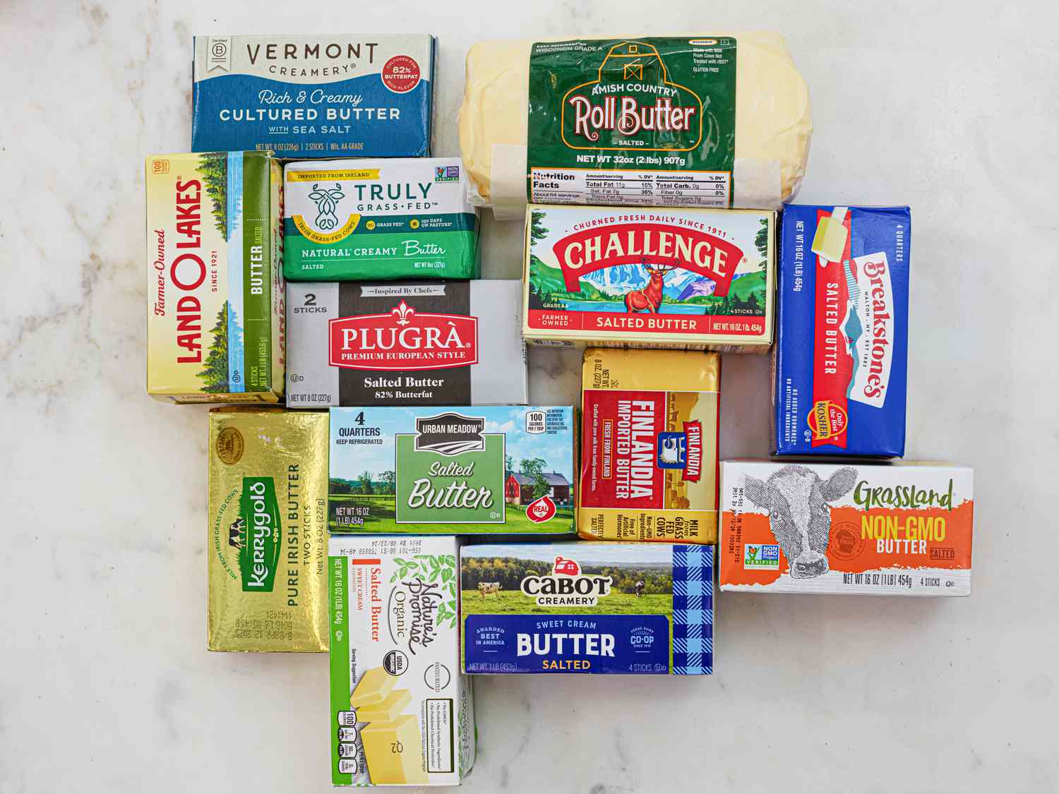 An assortment of salted butters on a white marble countertop.
