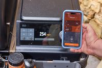A person adjusts the temperature on the Traeger Ironwood XL using an app on their smartphone