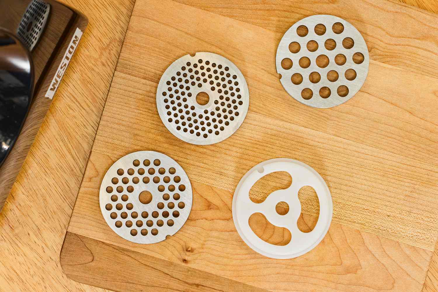 Grinding plates displayed on wooden board