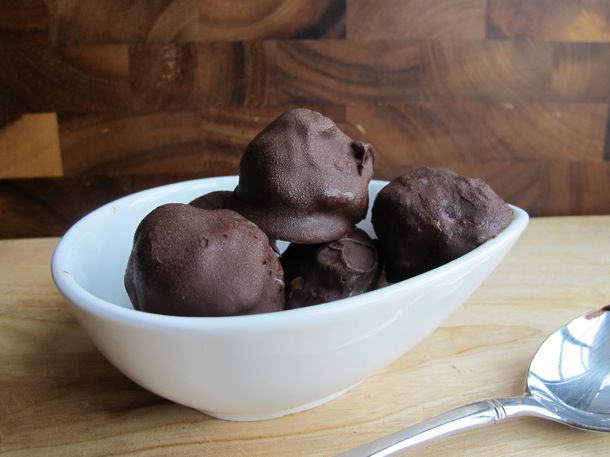 A bowl of chocolate ice cream bon bons, ready to serve.
