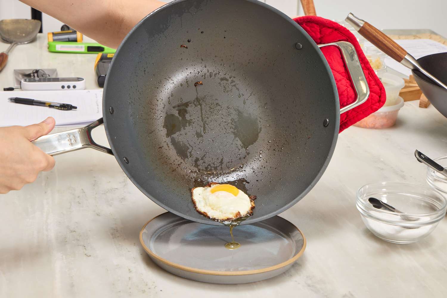 An egg cooked in the Misen 12 Inch Carbon Steel Wok is placed on a plate