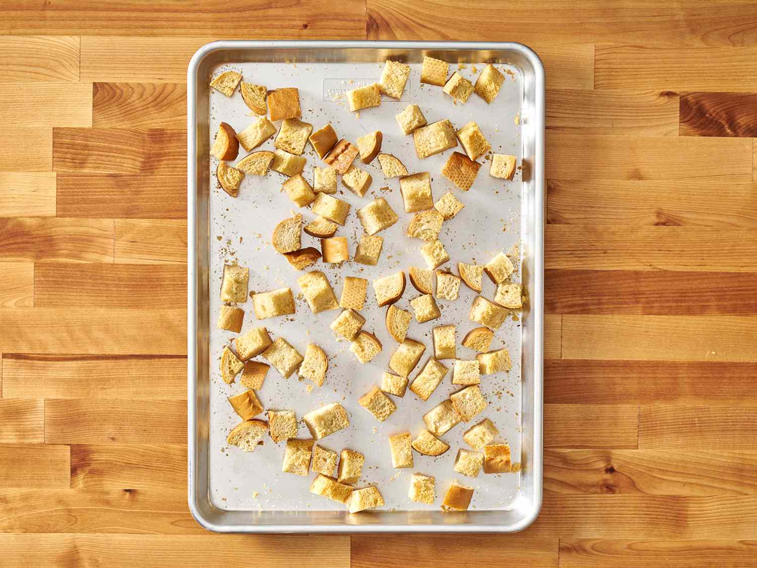 Cubes of bread in a sheet pan after being dried in a low oven