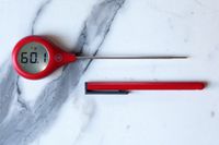 A red ThermoWorks Thermopop on a marble countertop.