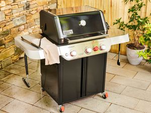 The Weber Genesis E-325 Liquid Propane Gas Grill on a patio