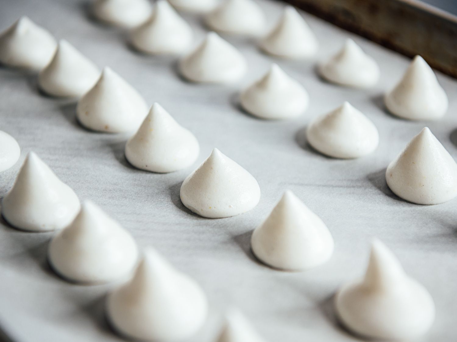 a tray of baked aquafaba-cardamom meringue cookies