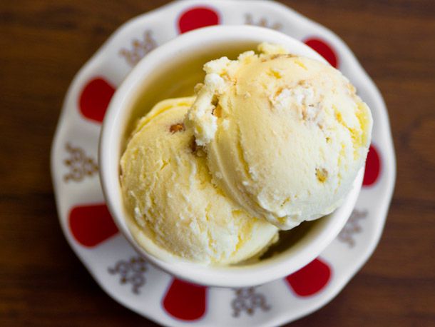 An overhead view of two scoops of buttered popcorn ice cream in a dish on a saucer.