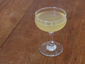 A bee's knees cocktail in a coupe. 